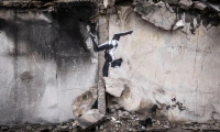 Mural by Banksy in Borodyanka (Gymnast does a handstand amid debris)