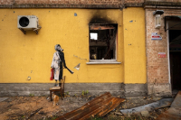 Mural by Banksy in Gostomel (Woman with a gas mask on her head)